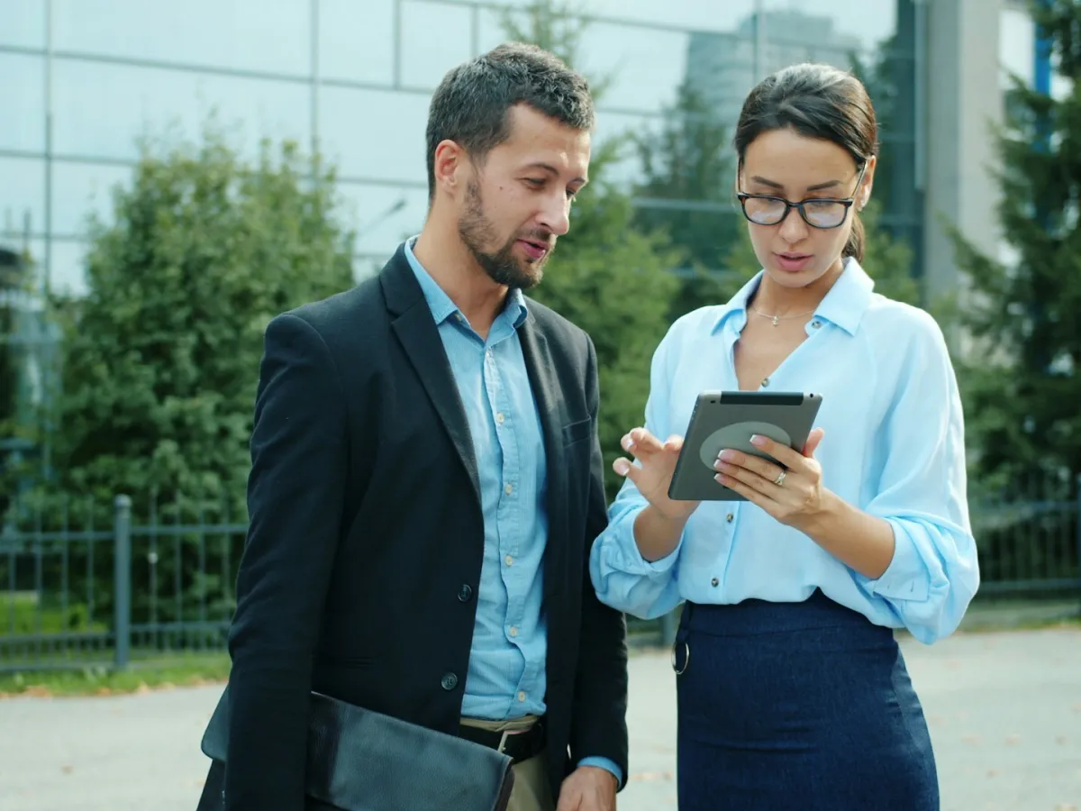 Two business people look at tablet